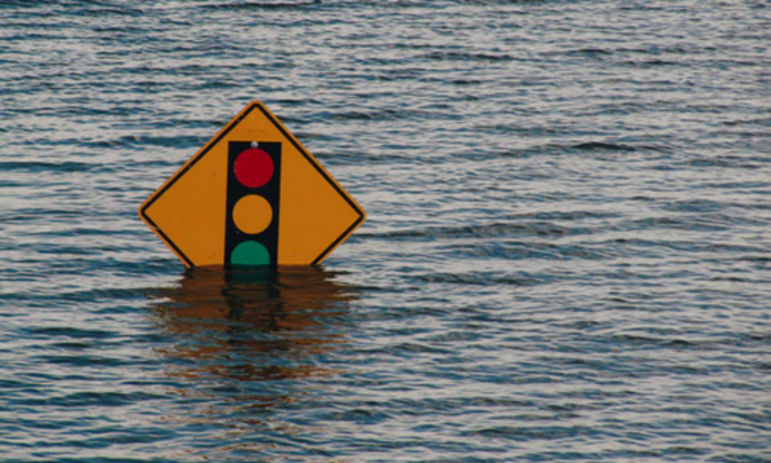 Flooding - Traffic sign just rising above the surrounding water