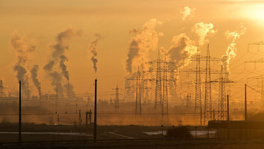 Smoke rising over a power plant