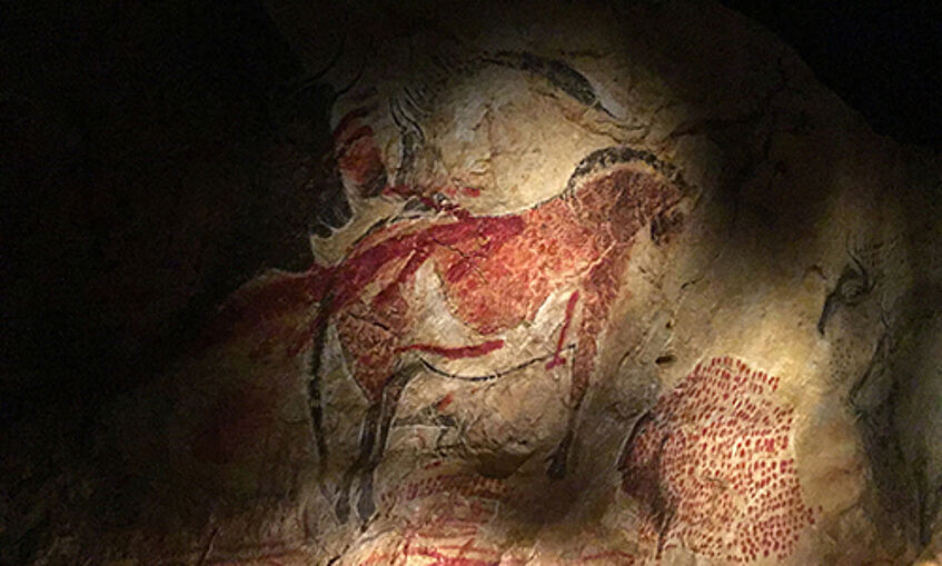 Painting of a pre-historic animal on a cave wall