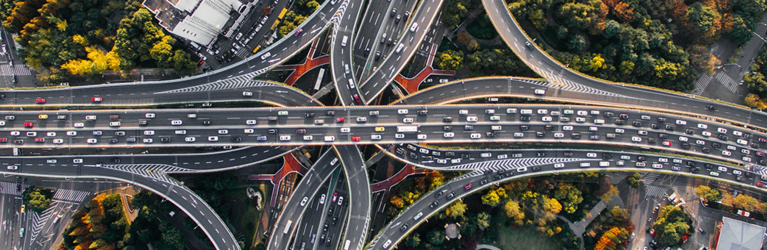 Bird's eye view of a highway intersection with heavy traffic